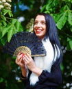 Smiling young woman smelling a beautiful blossom Royalty Free Stock Photo