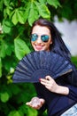 Smiling young woman smelling a beautiful sakura Royalty Free Stock Photo