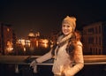 Smiling young woman standing on a bridge overlooking Grand canal