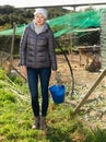 Woman standing near henhouse Royalty Free Stock Photo