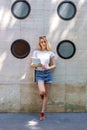 Smiling young woman standing on the street while waiting for somebody Royalty Free Stock Photo