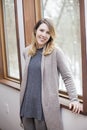 Happy woman at home by window in winter Royalty Free Stock Photo