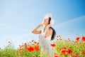 Smiling young woman in straw hat on poppy field Royalty Free Stock Photo