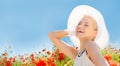 Smiling young woman in straw hat on poppy field Royalty Free Stock Photo