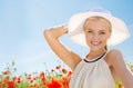 Smiling young woman in straw hat on poppy field Royalty Free Stock Photo