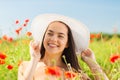 Smiling young woman in straw hat on poppy field Royalty Free Stock Photo