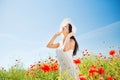 Smiling young woman in straw hat on poppy field Royalty Free Stock Photo