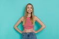 Smiling Young Woman In Striped Tank Top Is Posing With Hands On Hip Royalty Free Stock Photo