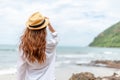 Smiling young woman in sun hat on beach. summer, holidays, vacation, travel concept Royalty Free Stock Photo