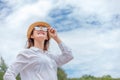 Smiling young woman in sun hat and waring sun glasses on the  beach. summer, holidays, vacation, travel concept Royalty Free Stock Photo