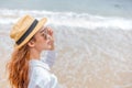 Smiling young woman in sun hat and waring sun glasses on the  beach. summer, holidays, vacation, travel concept Royalty Free Stock Photo