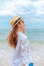 Smiling young woman in sun hat and waring sun glasses on the  beach. summer, holidays, vacation, travel concept Royalty Free Stock Photo