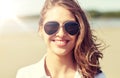 Smiling young woman in sunglasses on beach Royalty Free Stock Photo