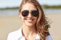 Smiling young woman in sunglasses on beach Royalty Free Stock Photo