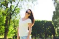 Smiling young woman with sunglasses in park