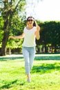 Smiling young woman with sunglasses in park