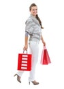 Smiling young woman in sweater with christmas shopping bags Royalty Free Stock Photo