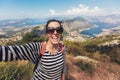 Smiling young woman takes a selfie on background mountain and sea Royalty Free Stock Photo