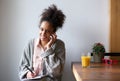 Smiling young woman taking notes with pen and paper at home Royalty Free Stock Photo