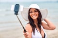 Smiling young woman taking selfie with smartphone Royalty Free Stock Photo