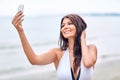 Smiling young woman taking selfie with smartphone Royalty Free Stock Photo