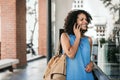 Smiling young woman talking on her cellphone while out shopping Royalty Free Stock Photo