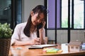 Smiling woman talking on mobile phone and using digital tablet. Royalty Free Stock Photo