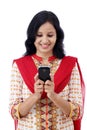 Smiling young woman texting against white Royalty Free Stock Photo