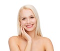 Smiling young woman touching her face skin Royalty Free Stock Photo