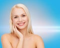 Smiling young woman touching her face skin Royalty Free Stock Photo