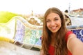 Smiling young woman tourist taking selfie self portrait sitting Royalty Free Stock Photo