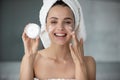 Smiling young female recommend moisturizing facial cream Royalty Free Stock Photo