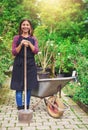 Smiling young woman transplanting nursery stock