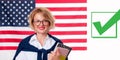 Smiling young woman on United States flag background. Royalty Free Stock Photo