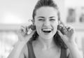 Young woman using cherry tomato as earrings Royalty Free Stock Photo