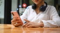 Smiling young woman using mobile phone for sharing and commenting in online community Royalty Free Stock Photo