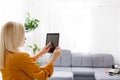 Elegant young businesswoman using tablet, looking at screen Royalty Free Stock Photo