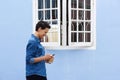 Smiling young woman walking outside with cellphone Royalty Free Stock Photo