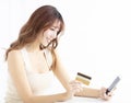 young woman watching mobile phone and credit card Royalty Free Stock Photo