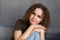 Smiling young woman wearing casual clothes relaxing on a couch at home Royalty Free Stock Photo