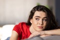 Smiling pretty young woman wearing casual clothes relaxing on a couch at home Royalty Free Stock Photo