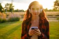 Smiling young woman wearing wireless headphones for listening to the music via smartphone. Royalty Free Stock Photo