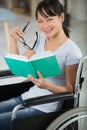 smiling young woman in wheelchair looking at camera Royalty Free Stock Photo