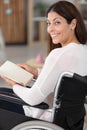 smiling young woman in wheelchair looking at camera Royalty Free Stock Photo