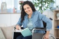 smiling young woman in wheelchair looking at camera Royalty Free Stock Photo