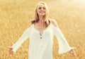 Smiling young woman in white dress on cereal field Royalty Free Stock Photo