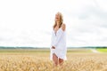 Smiling young woman in white dress on cereal field Royalty Free Stock Photo