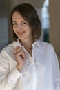 Smiling young woman in white shirt. Business woman in formal clothes. Close up portrait Royalty Free Stock Photo