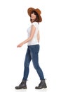 Smiling Young Woman In White T-Shirt And Hat Is Walking And Looking At Camera Royalty Free Stock Photo