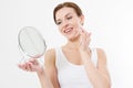 Smiling young woman with white teeth looking in mirror isolated on white background. Skin care and anti aging concept. Beauty Royalty Free Stock Photo